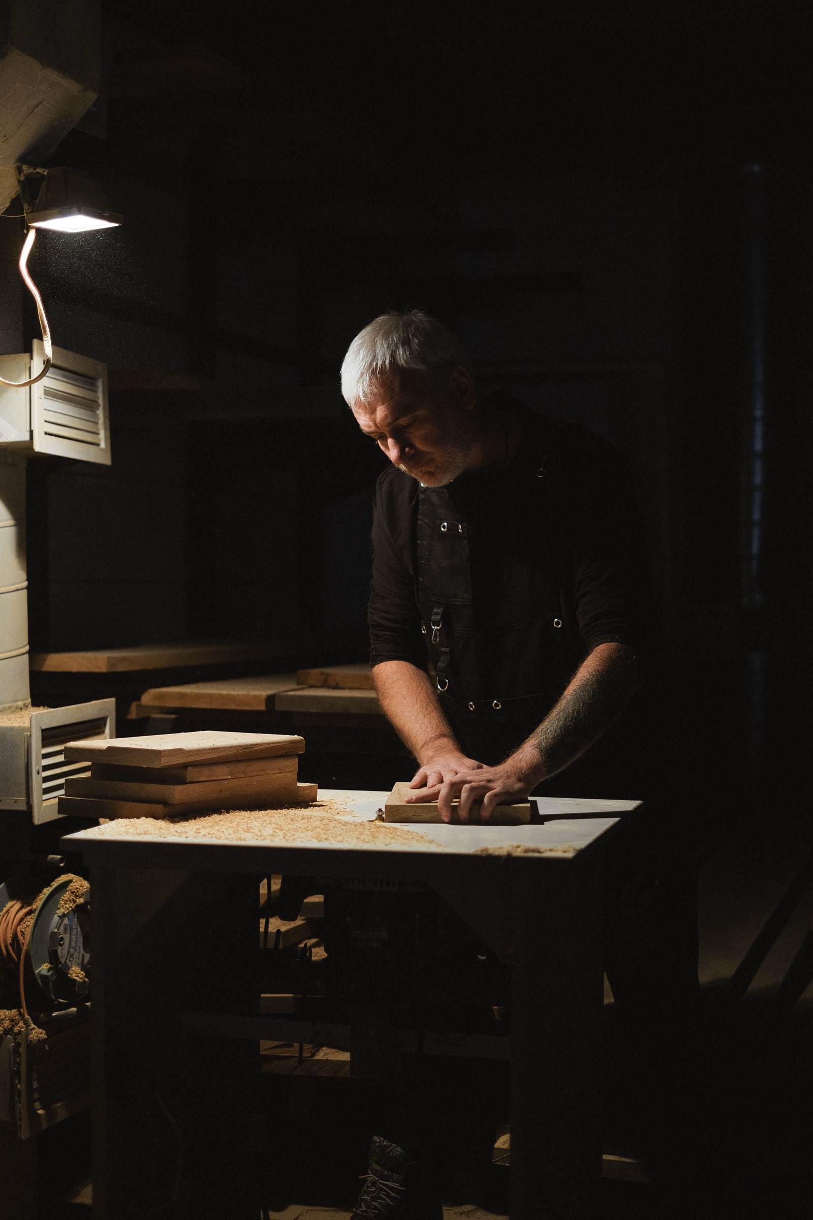 Tomas Kacera sanding a white oak panel in the Kacera shop